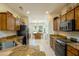 Well-lit kitchen with granite countertops, wood cabinets, and modern appliances at 16495 W Monteverde Ln, Surprise, AZ 85374