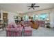 Bright and airy living room featuring large windows, neutral walls, and comfortable, colorful seating at 16495 W Monteverde Ln, Surprise, AZ 85374