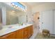 Spacious main bathroom featuring double sinks, a large mirror with great lighting, and a separate toilet area at 16495 W Monteverde Ln, Surprise, AZ 85374