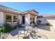 Charming patio with seating area, complemented by desert landscaping and tranquil ambiance at 16495 W Monteverde Ln, Surprise, AZ 85374