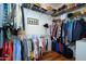Walk-in closet features built-in shelves and hanging racks, offering ample storage space for clothing and accessories at 16495 W Monteverde Ln, Surprise, AZ 85374