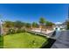 This backyard features a pool, putting green, and well-maintained landscaping at 17336 W Crawfordsville Dr, Surprise, AZ 85388