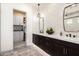 Modern bathroom with double vanity, sleek fixtures, and access to a walk-in closet at 17336 W Crawfordsville Dr, Surprise, AZ 85388