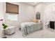 Cozy bedroom with a plush bed, chair, and view into the bathroom at 17336 W Crawfordsville Dr, Surprise, AZ 85388