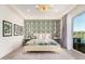 Bright bedroom featuring a king bed, chandelier, and sliding doors with a view of the pool at 17336 W Crawfordsville Dr, Surprise, AZ 85388