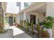 Charming courtyard featuring a walkway with desert landscaping, potted plants, and stylish lighting at 17336 W Crawfordsville Dr, Surprise, AZ 85388