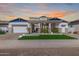 Stunning two-story home with a well-manicured lawn, a three-car garage, and desert landscaping at 17336 W Crawfordsville Dr, Surprise, AZ 85388