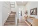 Bright foyer featuring wood floors, staircase with white railings and natural wood console table at 17336 W Crawfordsville Dr, Surprise, AZ 85388
