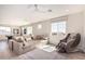 Spacious game room featuring pool table, sectional sofa, massage chair and lots of natural light at 17336 W Crawfordsville Dr, Surprise, AZ 85388