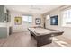 Inviting game room with a pool table, stylish light fixture, and framed sports memorabilia at 17336 W Crawfordsville Dr, Surprise, AZ 85388