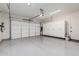 This garage has an epoxy floor and a large garage door at 17336 W Crawfordsville Dr, Surprise, AZ 85388