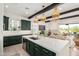 Open kitchen view, with a large island, green cabinetry, and open views of the living area at 17336 W Crawfordsville Dr, Surprise, AZ 85388