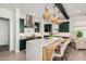 Stylish kitchen with a large island, stainless steel range hood, and modern appliances at 17336 W Crawfordsville Dr, Surprise, AZ 85388