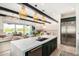 Spacious kitchen features a large island with bar seating and an open layout connected to the living area at 17336 W Crawfordsville Dr, Surprise, AZ 85388
