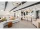 Bright and airy living room featuring an open floor plan, modern furnishings, and exposed beam ceilings at 17336 W Crawfordsville Dr, Surprise, AZ 85388