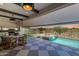 Relaxing outdoor area with a private pool, outdoor kitchen, dining and lounge seating with sunset views at 17336 W Crawfordsville Dr, Surprise, AZ 85388