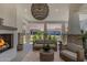 Cozy outdoor living space with a fireplace, comfortable seating, and neighborhood views at 17336 W Crawfordsville Dr, Surprise, AZ 85388
