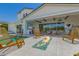 Beautiful outdoor living space featuring a fire pit, an outdoor kitchen and an expansive covered patio at 17336 W Crawfordsville Dr, Surprise, AZ 85388