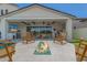 Beautiful outdoor living space featuring a fire pit, an outdoor kitchen and an expansive covered patio at 17336 W Crawfordsville Dr, Surprise, AZ 85388
