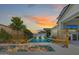 This backyard features a pool, seating area, outdoor kitchen and an expansive covered patio at 17336 W Crawfordsville Dr, Surprise, AZ 85388