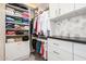 Well-organized walk-in closet with custom shelving, drawers, and ample storage space at 17336 W Crawfordsville Dr, Surprise, AZ 85388