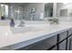 Modern bathroom featuring a white countertop and dual sink with chrome faucet at 17563 W Summit Dr, Goodyear, AZ 85338