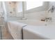 Bright bathroom featuring a soaking tub, a shower with glass door, and white tile at 17563 W Summit Dr, Goodyear, AZ 85338
