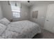 Cozy bedroom features neutral tones, a comfortable bed, and ample natural light from the window at 17563 W Summit Dr, Goodyear, AZ 85338