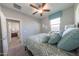 Comfortable bedroom with patterned bedding and pillows, complemented by a bright window and neutral decor at 17563 W Summit Dr, Goodyear, AZ 85338