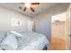 Well-lit bedroom features a ceiling fan, walk-in closet, and a comfortable bed with blue patterned bedding at 17563 W Summit Dr, Goodyear, AZ 85338