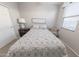 Comfortable bedroom features a large bed with patterned linens, complemented by soft natural light at 17563 W Summit Dr, Goodyear, AZ 85338