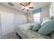 Neutral bedroom design features plush bedding, soft window lighting, and a view of a closed, white door at 17563 W Summit Dr, Goodyear, AZ 85338