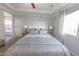 Bright bedroom featuring a king bed with decorative pillows and a stylish accent wall at 17563 W Summit Dr, Goodyear, AZ 85338