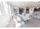 Sunlit dining area showcasing a glass-top table, comfortable chairs, and a cozy rug at 17563 W Summit Dr, Goodyear, AZ 85338