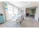 Bright dining room featuring large windows, stylish furniture, and neutral decor at 17563 W Summit Dr, Goodyear, AZ 85338
