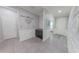 Charming entryway with gray tile flooring and mudroom features that include a coat rack and storage at 17563 W Summit Dr, Goodyear, AZ 85338