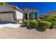 Charming home with neutral tones, desert landscaping, and gated front patio at 17563 W Summit Dr, Goodyear, AZ 85338