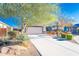 Attractive single-story home with a desert landscaped front yard and a two car garage at 17563 W Summit Dr, Goodyear, AZ 85338