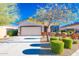 Charming single-story home featuring a well-manicured lawn and a two car garage at 17563 W Summit Dr, Goodyear, AZ 85338