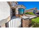 Inviting front porch with seating and wrought-iron gate adds charm to this lovely home at 17563 W Summit Dr, Goodyear, AZ 85338