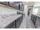 Kitchen with dark cabinetry, granite counters, and stainless appliances at 17563 W Summit Dr, Goodyear, AZ 85338
