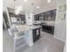 Well-appointed kitchen with dark cabinets, granite counters, and stainless steel appliances at 17563 W Summit Dr, Goodyear, AZ 85338