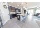 Modern kitchen featuring dark cabinetry, stainless appliances, and a large island with bar seating at 17563 W Summit Dr, Goodyear, AZ 85338
