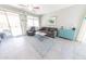 Bright living room with neutral tones, comfortable furniture, and access to outdoor space at 17563 W Summit Dr, Goodyear, AZ 85338