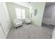 Bright room with large window features comfortable seating, plantation shutters, and soothing green walls at 17563 W Summit Dr, Goodyear, AZ 85338