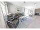 Inviting living room with a comfortable seating arrangement, stylish rug, and bright, airy ambiance at 17563 W Summit Dr, Goodyear, AZ 85338