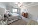 Spacious main bedroom with soft carpeting, large bed, stylish dresser, and a window for natural light at 17563 W Summit Dr, Goodyear, AZ 85338