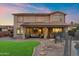 This backyard features a covered patio, a lush lawn, mature landscaping, and a sparkling pool, perfect for outdoor living at 1835 E Bartlett Pl, Chandler, AZ 85249