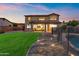 Beautiful backyard with a covered patio, lush lawn, stepping stones, and a fenced pool for a perfect outdoor retreat at 1835 E Bartlett Pl, Chandler, AZ 85249