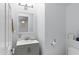 Powder bathroom with light gray vanity and decorative mirror, offering a clean and modern look at 1835 E Bartlett Pl, Chandler, AZ 85249